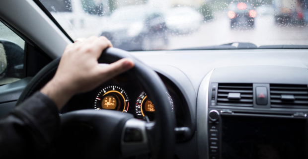 Une aiguille hors champ à 12 heures sur un volant, à travers le volant, on peut voir les indications du compteur kilométrique et du compteur de vitesse. 
