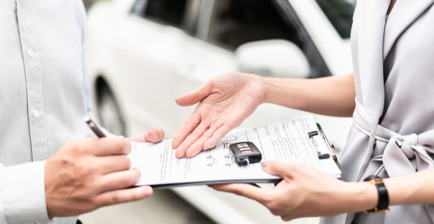 Un nouveau conducteur consultant des informations sur l’assurance automobile avant de prendre le volant d’un véhicule.  